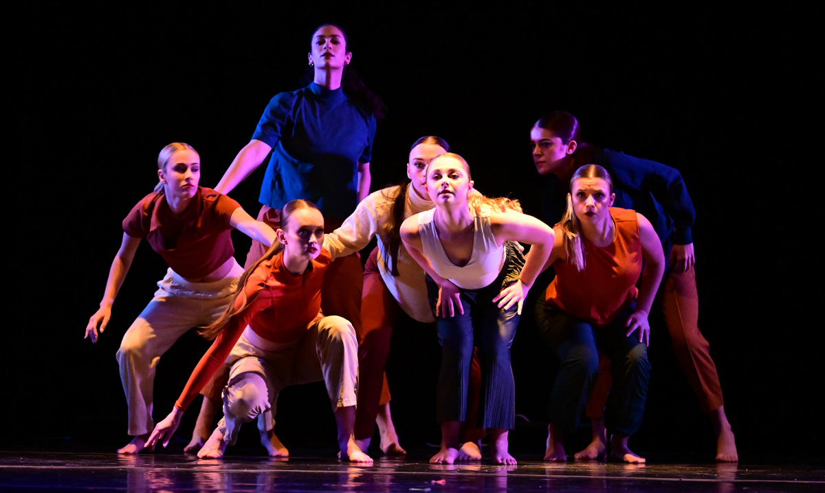 students performing a choreography on stage