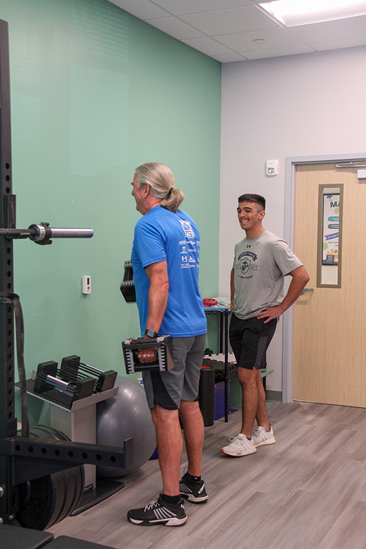 JU Exercise Science student supervises patient as they exercise
