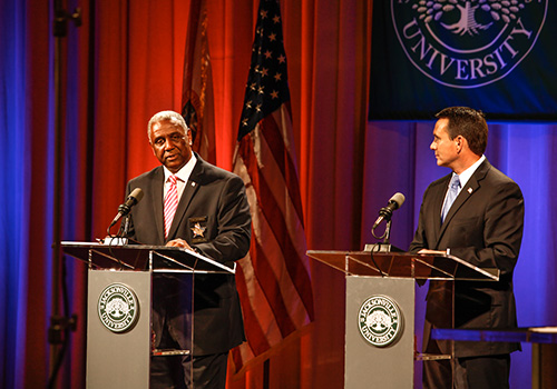 Two Jacksonville leaders speak to an audience from a stage