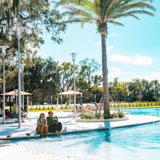students seating by the pool