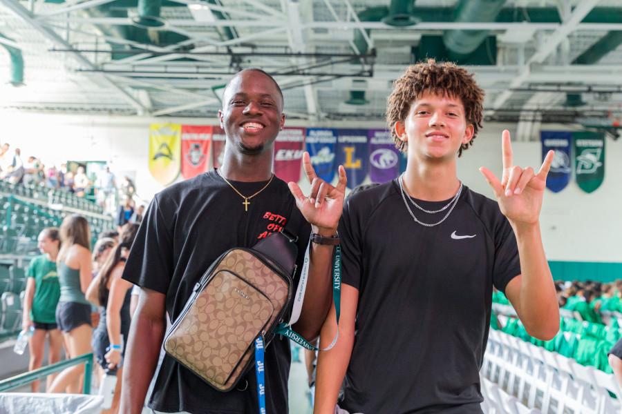 Jacksonville University students doing the Phin's Up! hand sign.