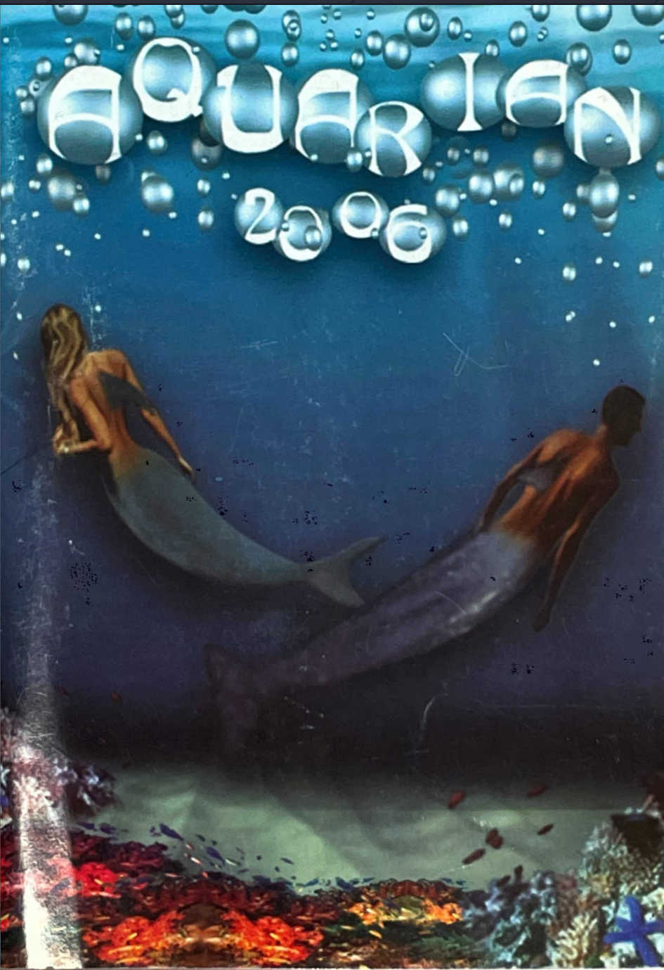 Two mermaids swimming in the ocean with bubbles around them making the Aquarian 2006 title