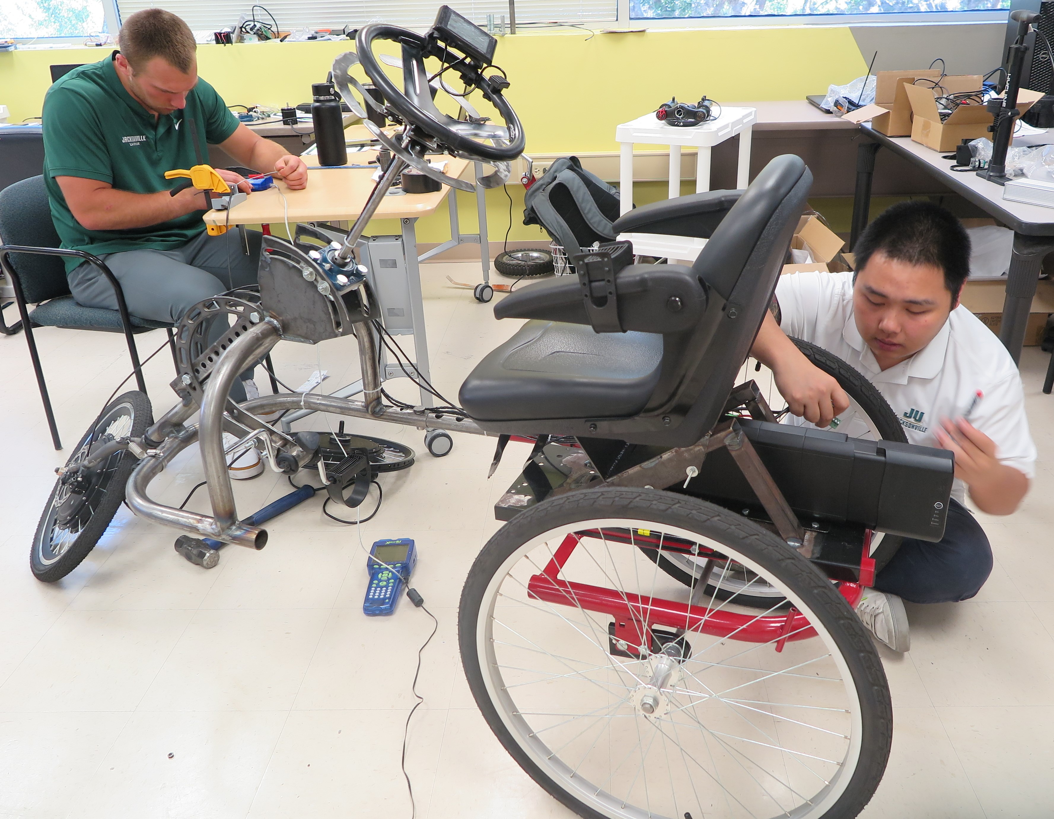 students working on tricycle
