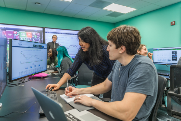 Student and teacher looking at computer screen