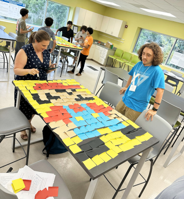 Two students working on building plastic robots. 