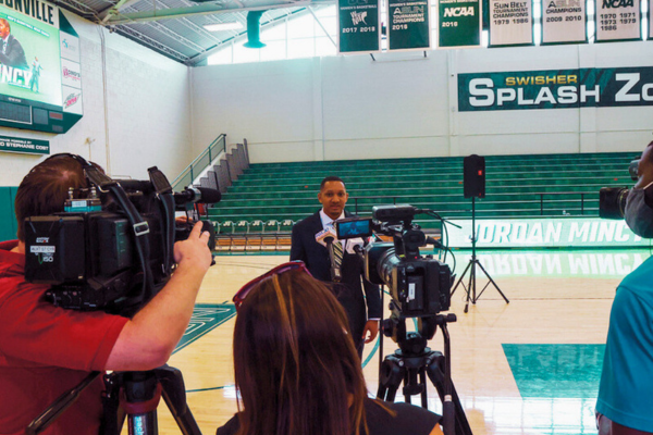 JU Sport Business student being interviewed in the JU gymnasium.