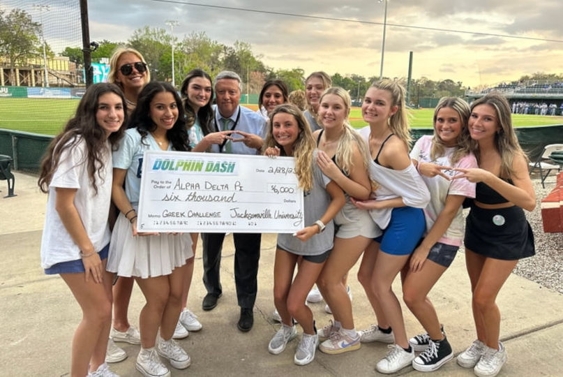 President Tim Cost posing with Greek Challenge Winners at Dolphin Dash