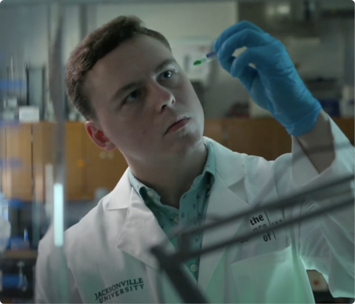 A photo of Tyler Kopf wearing a lab coat.