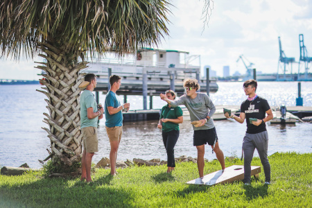 A group of students by the Naargard Docks with the St John's River in the background