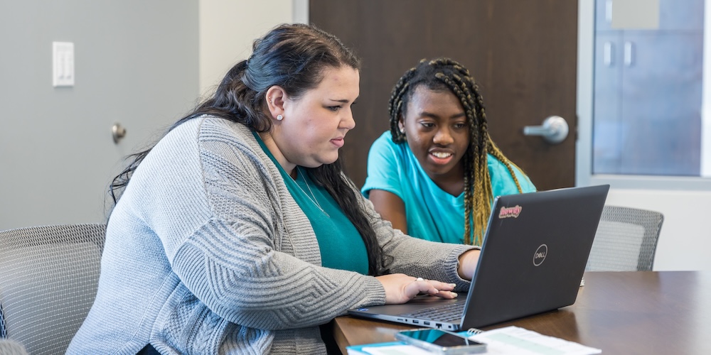 Students studying together on a laptop