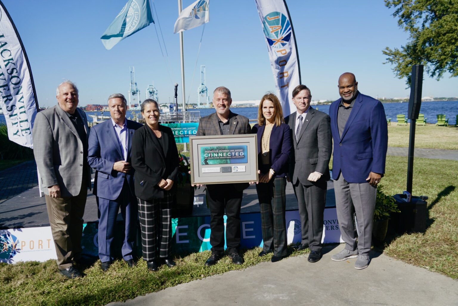 Several of the JAXPORT and JU executives at the launch of Connected, posed in front of the St. Johns River